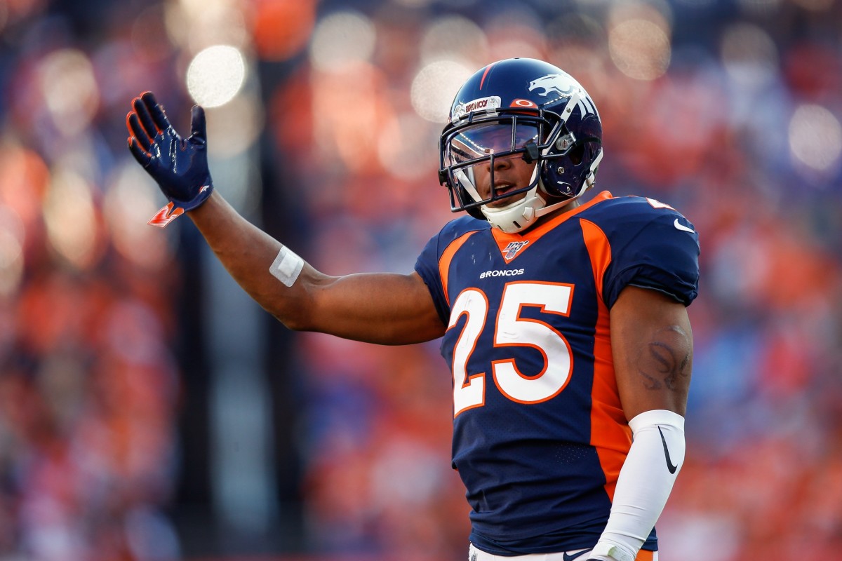Denver Broncos cornerback Chris Harris Jr. (25) motions in the third quarter against the Tennessee Titans at Empower Field at Mile High.